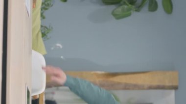 Vertical Video of Mature Adult Man Coming Back to Office and Opening Laptop