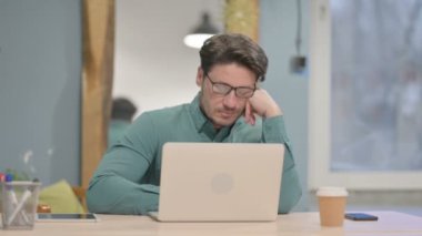 Mature Adult Businessman Sleeping while Sitting in Office