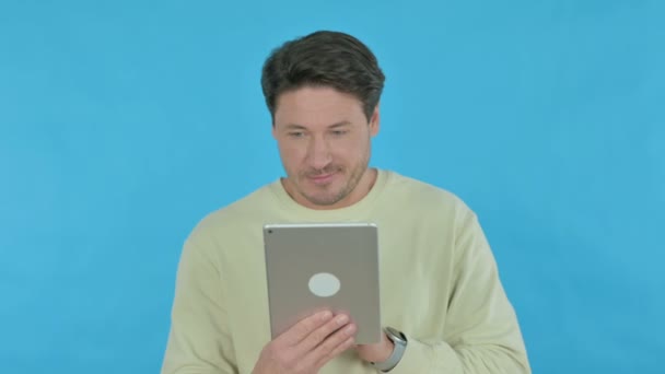Handsome Young Man Using Digital Tablet Blue Background — Vídeo de Stock