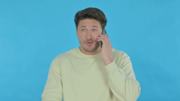 Handsome Young Man Talking Phone Blue Background — Αρχείο Βίντεο