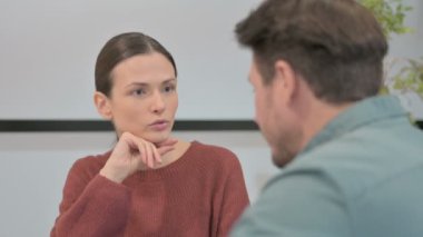 Young Woman Talking to Fellow Colleague in Office