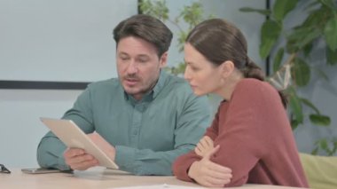 Young Creative Business People Discussing Work on Tablet