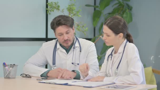 Male Female Doctor Discussing Patient Medical Report — Vídeos de Stock