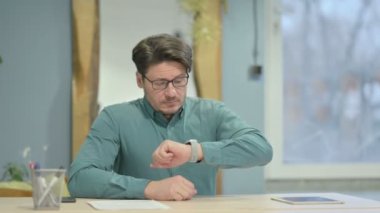 Mature Adult Businessman Leaving Office after Closing Laptop