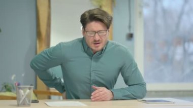 Mature Adult Businessman Sleeping while Sitting in Office