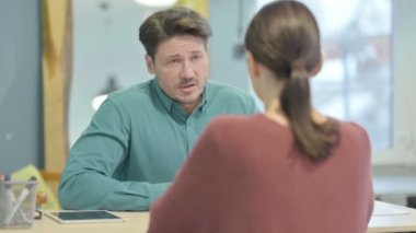Young Creative Man Talking with Employee in Office