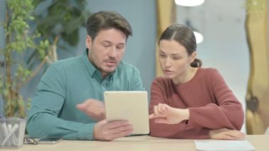 Young Woman Talking to Fellow Colleague in Office