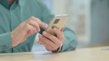 Close up of Male Hands Browsing Internet on Smartphone
