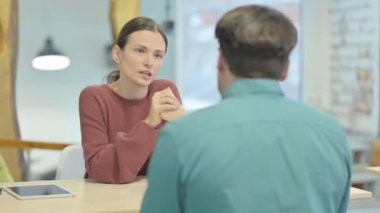 Angry Woman Arguing with Male Teammate