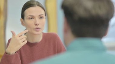 Close Up of Creative Young Woman Talking to Teammate