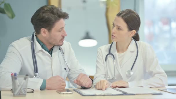 Male Female Doctor Discussing Patient Medical Report — Stockvideo