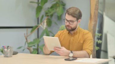 Shocked Middle Aged Businessman Reacting to Loss on Digital Tablet