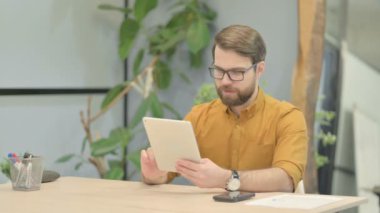 Online Video Chat on Tablet by Middle Aged Businessman