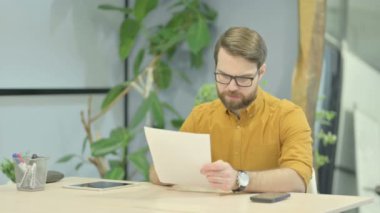 Middle Aged Businessman Feeling Upset after Reading Documents, Paperwork