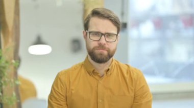 Portrait of Middle Aged Businessman Shaking Head in Approval