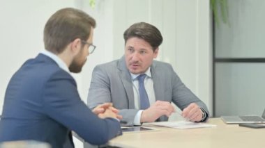 Ofisinde toplantıda konuşan iş adamları