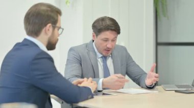 Angry Businessman in Argument with Teammate in Office