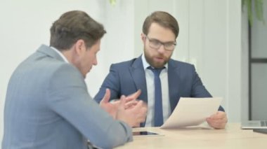 Angry Businessman in Argument with Teammate in Office