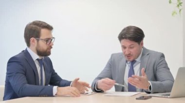 Unsatisfied Businessman Discussing Business Report in Office