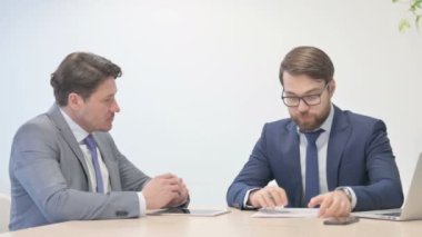 Businessman Talking with Worker in Office