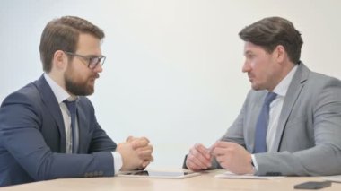 Middle Aged Businessman Talking with Partner at Work