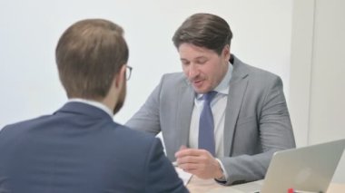 Successful Businessman Talking with Team member at Work