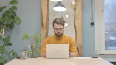 Middle Aged Businessman Typing on Laptop at Work