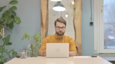 Thumbs Up by Middle Aged Businessman Working on Laptop