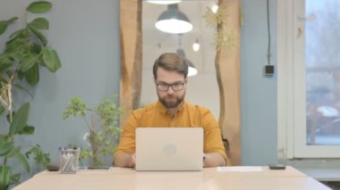 Middle Aged Businessman Shocked While Working on Laptop