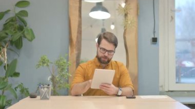 Shocked Middle Aged Businessman Reacting to Loss on Digital Tablet