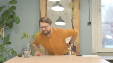 Middle Aged Businessman with Spinal Back Pain at Work