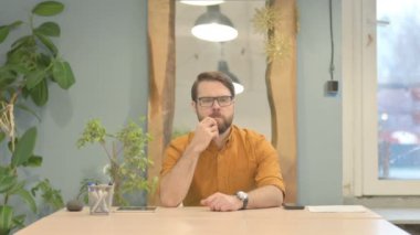 Middle Aged Businessman Leaving Office after Closing Laptop