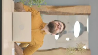 Middle Aged Businessman having Back Pain while using Laptop, Vertical Video