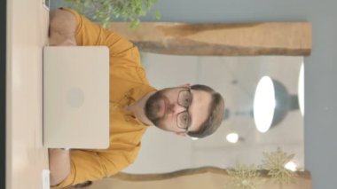 Thumbs Down by Middle Aged Businessman Working on Laptop, Vertical Video