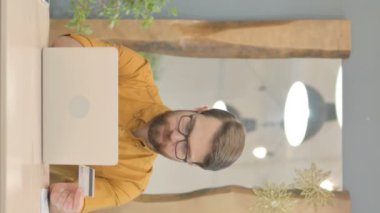 Middle Aged Businessman Unable to make Online Payment on Laptop, Vertical Video