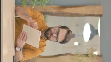 Middle Aged Businessman using Digital Tablet, Browsing Internet, Vertical Video