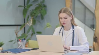 Young Doctor having Headache while Working on Laptop