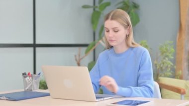 Young Woman Coming to Work, Typing on Laptop