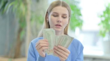Portrait of Casual Young Woman Counting Dollar