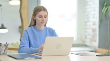 Young Woman Working on Laptop at Work
