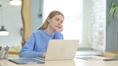 Young Woman Sleeping while Sitting at Work