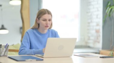 Young Woman Reacting to Online Loss on Laptop