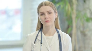 Portrait of Young Doctor Showing Thumbs Down