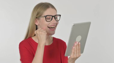 Casual Young Woman Celebrating Success on Tablet on White Background