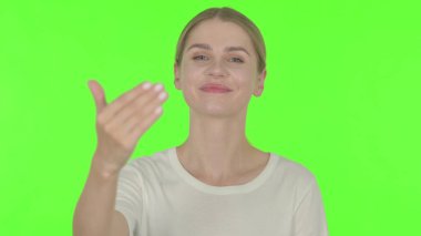 Casual Young Woman Pointing at Camera, Inviting on Green Background