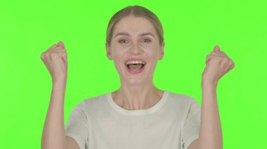Successful Casual Young Woman Celebrating on Green Background