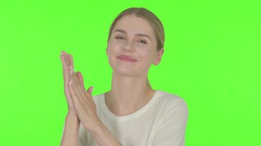 Casual Young Woman Clapping, Applauding on Green Background