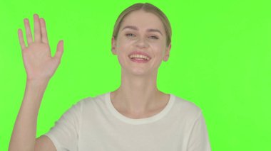 Casual Young Woman Talking on Video Call on Green Background