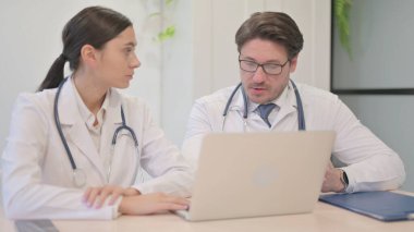 Doktor ekibi laptopta birlikte çalışıyor.