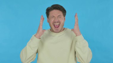 Angry Handsome Young Man Arguing on Blue Background